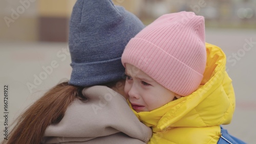 Tableau sur toile little child crying on shoulder mother, mother hugs capricious kid girl, daughter bad mood, baby shows her displeasure parent with hysteria, close-up, child expression of emotion with tears, sad face