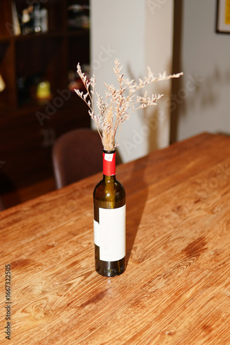 Wine Bottle Vase with Dried Flowers on Wooden Table