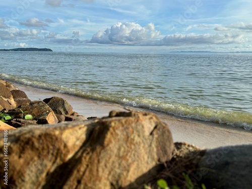 Sunny seaside with blue sky and white clouds, symbolizing freedom and wanderlust travel