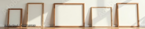 Set of diverse wooden picture frames against sleek wall, upscale setting, display, frame, wooden