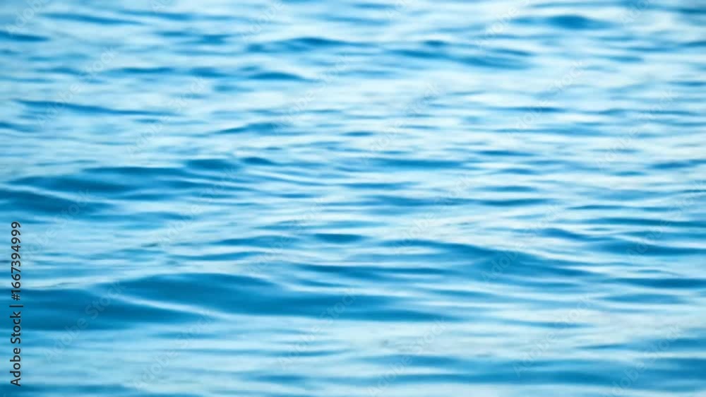 Rippling, sunlit water surface in hues of azure and cerulean, with gentle wave patterns creating a calming visual texture