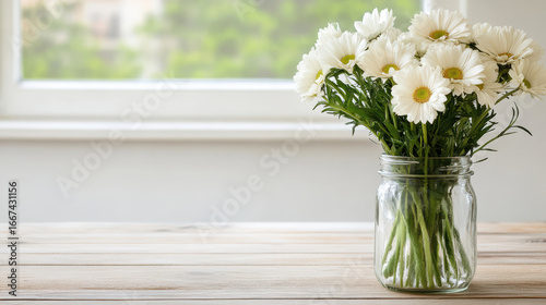 Fresh flowers in glass vase on wooden table, brightening room with natural beauty