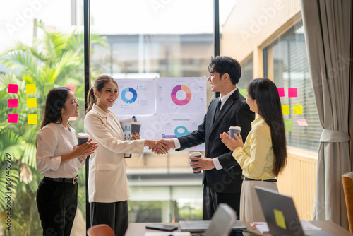 Business people shaking hands during meeting in modern office