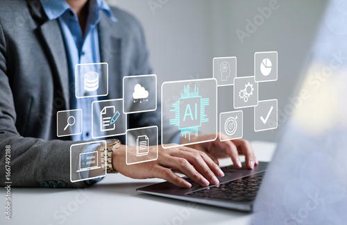 Businessman using laptop to control AI at desk in office. Artificial intelligence is analyzing data and generating reports. Artificial intelligence and intelligent automation (IA) technology.