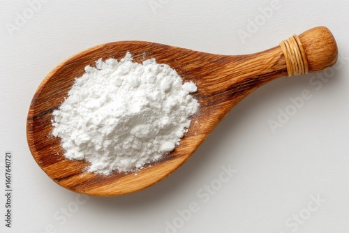 White flour in wooden spoon