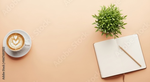 Minimalist Workspace Flat Lay with Latte Art, Notebook, and Plant on a Soft Peach Desk