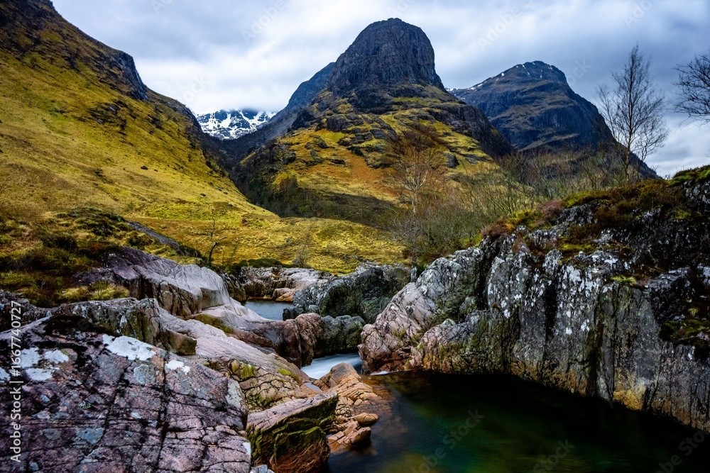Obraz premium River Coe flows through Glen Coe with The Three Sisters mountains in early spring, Scotland