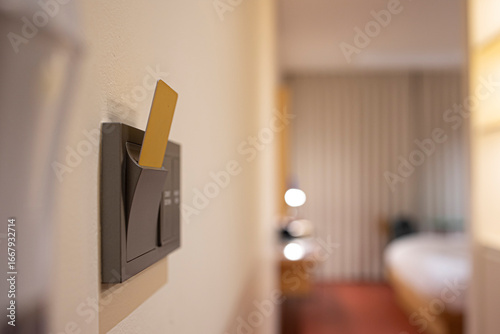 Insert key card in electronic lock in hotel