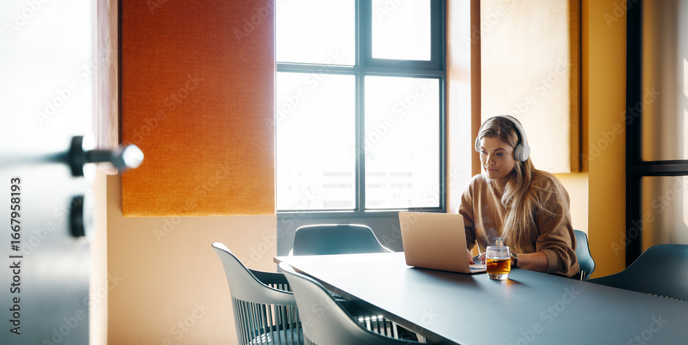 custom made wallpaper toronto digitalYoung woman working on a laptop with headphones in a modern office