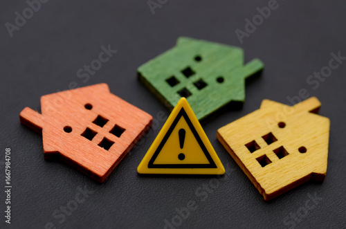 Three Miniature Houses with Warning Exclamation Sign — Real Estate Risk and Hazard Concept