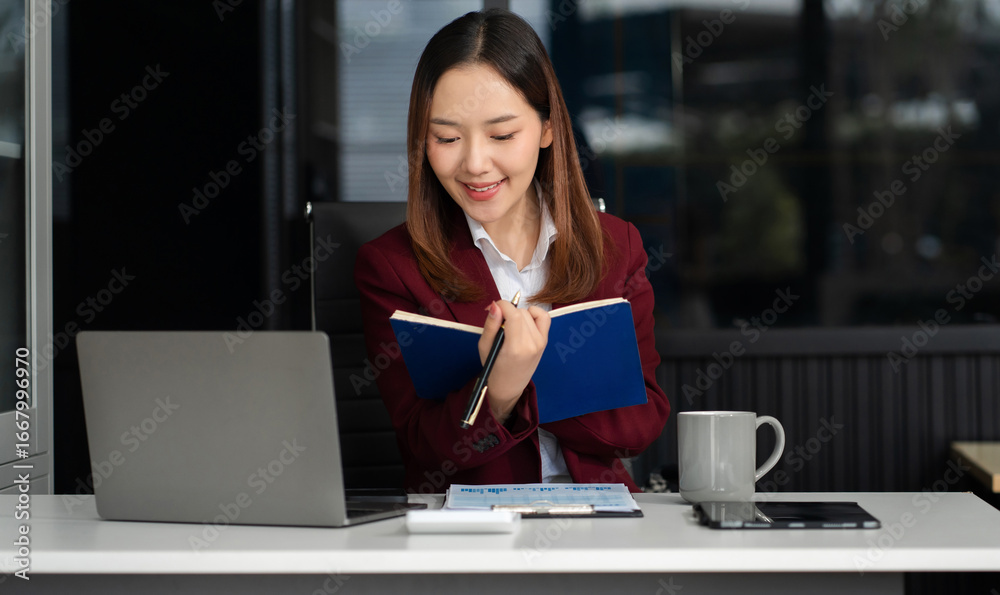 Business woman using computer working online, doing searching, taking notes looking at smartphone at work. Business woman using computer working online, doing searching, taking notes looking at smartphone at work.