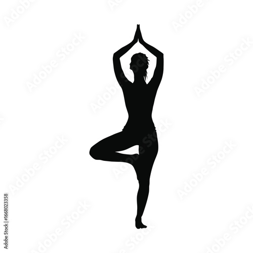 Silhouette of a Woman Practicing Yoga's Tree Pose Against a Black Background