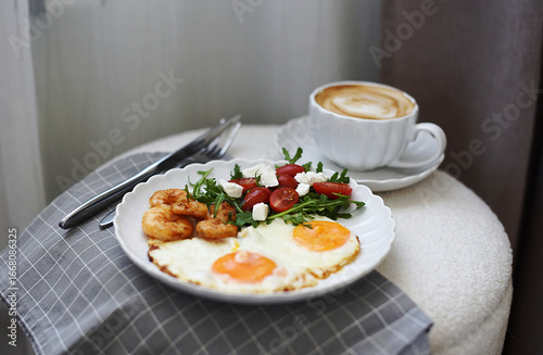 Tasty Fried Egg Served on a White Plate with Salad and Shrimps Cup with Cappuccino Healthy Breakfast
