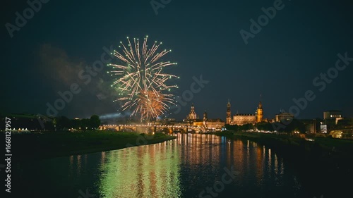 06. Colorful fireworks light up the night sky over Dresden during the Canaletto festival on City Day. The historic skyline and reflections on the Elbe River create a festive and vibrant atmosphere.