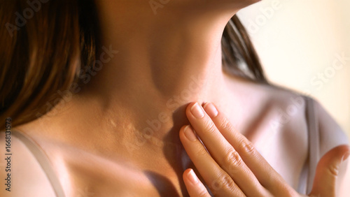 Fotografía Close-up of an unrecognizable woman touching her neck