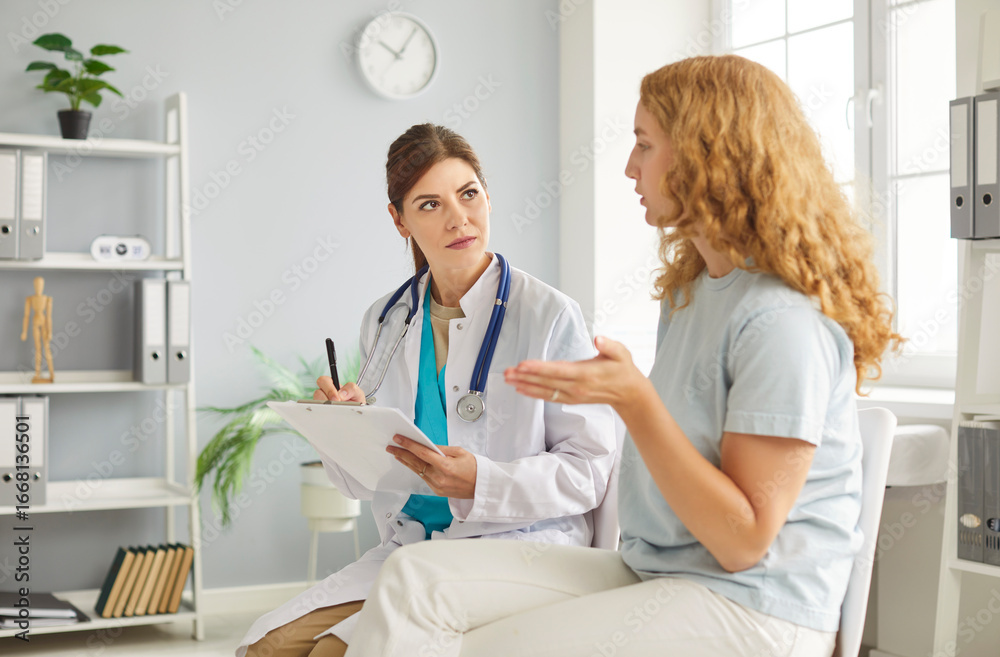 Fototapeta premium Caring young female nurse, doctor, caretaker talking. assisting helping woman patient in rehabilitation recovery during medical checkup visit for healthcare, examination, caregiver chatting to support