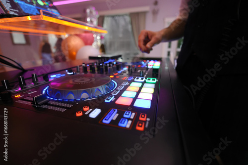 DJ table mixer closeup in the nightclub during the event party