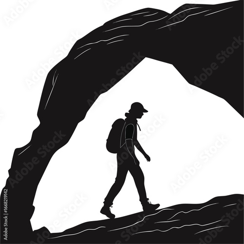 Person hiking through desert arch silhouette