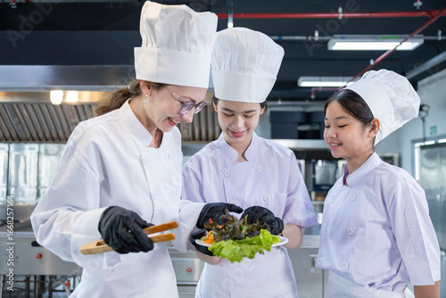 Chef instructor teaching students in kitchen class