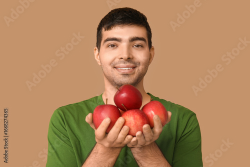 Young man with apples rich ...