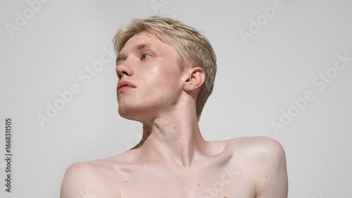 Fotografie Male beauty portrait with glowing skin and sculpted jawline
