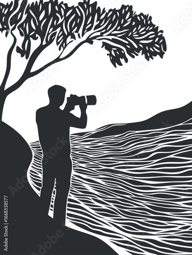 Silhouette of a photographer standing by a riverside with a tree overhead capturing nature's scenic view.