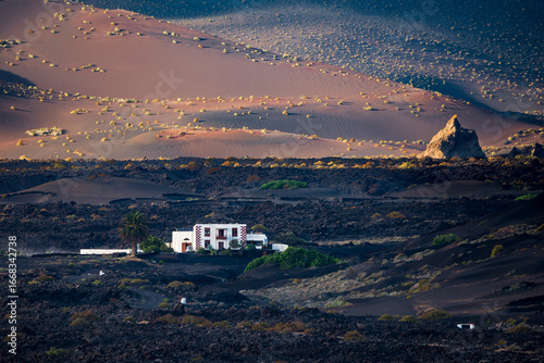 White country house surrounded by black volcanic soil in lanzarote, spain
