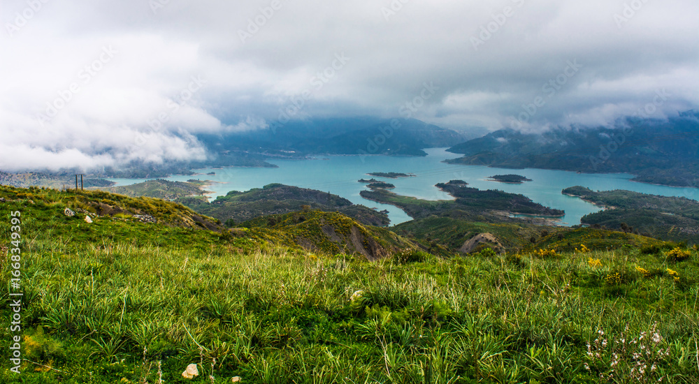 Obraz premium Beautiful landscape of lake and reflection of blue sky, clouds and mountains on surface of lake, Panoramic view of lake and snow-covered mountain and Forest trees calm in Jijel Algeria North African.