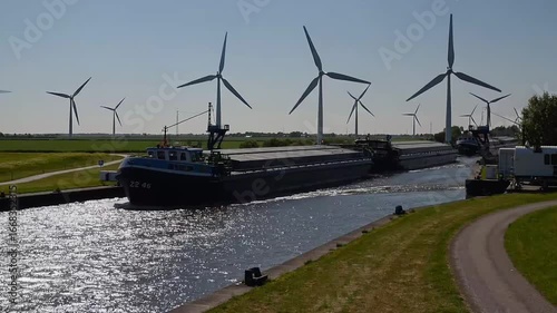 Waterway transit point and renewable energy converters situated in coastal region with movable barrier gate for vessels during the warm season