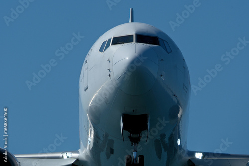 Close-Up of Passenger Jet Nose and Cockpit Windows. Airplane in the blue sky, close-up of the plane