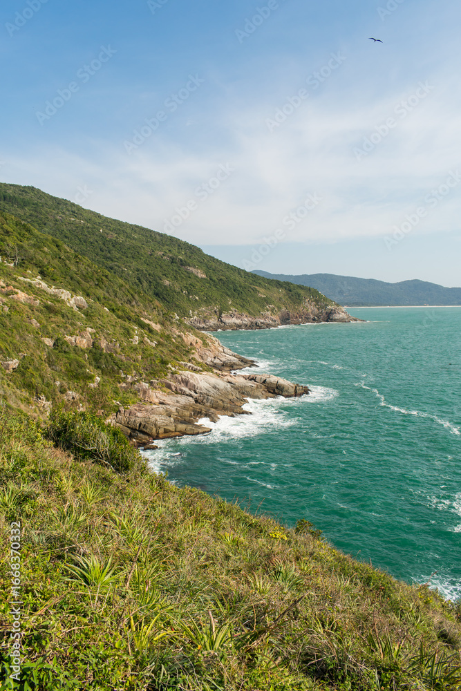 Fototapeta premium View from the hiking path to Lagoinha do Leste beach via Matadeiro. Cliffs, forest and atlantic ocean. Florianopolis, Brazil