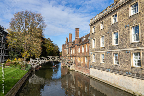 Cambridge, England. Wooden Mathematical Bridge of 1749 at Queens' College, designed by William Etheridge and built by James Essex, with a punt passing under on the River Cam