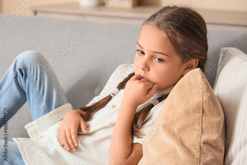 Little girl biting nails on...