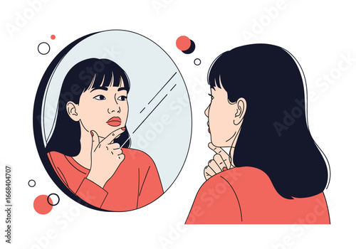 A young woman examines her face in the mirror with a thoughtful expression