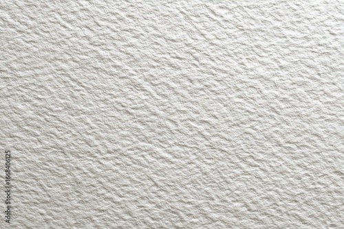Close-up of an off-white textured surface with a subtly uneven, granular, and slightly rough appearance, resembling a heavily textured paper or plaster