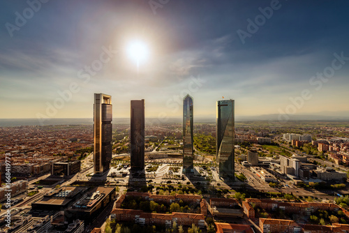 Aerial view of the Cuatro Torres Business Area skyscrapers in Madrid, Spain, at sunset