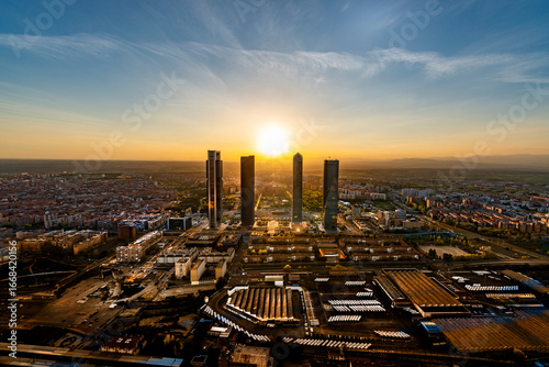 Aerial view of the Cuatro Torres Business Area skyscrapers in Madrid, Spain, at sunset