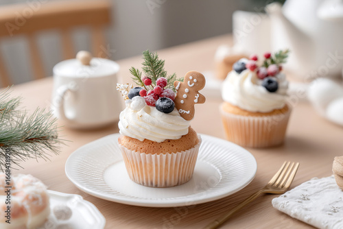 japanese christmas cupcake with berries and gingerbread man sitting on a light pine table with other pastries