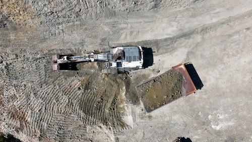 Excavator digging and a loaded dumper