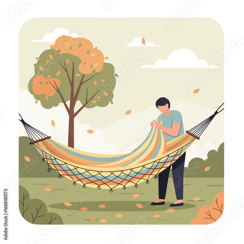 Person preparing a colorful hammock in an autumnal garden.