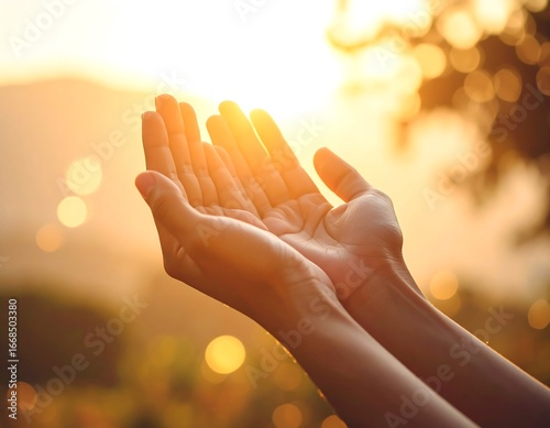 Human hands reaching out to the warm glow of the setting sun, symbolizing hope, blessing, and a connection to nature's serene beauty during a golden hour moment