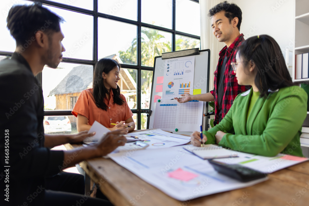 Fototapeta premium Young Asian entrepreneurs are discussing business strategy, presentation during a meeting in office.