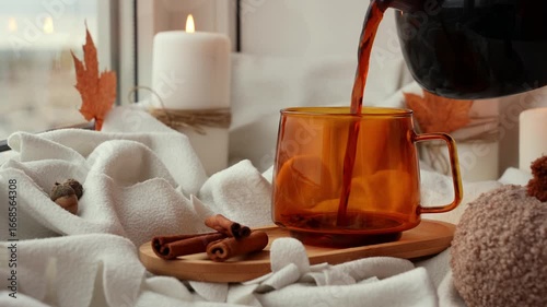 Pour coffee into cup Pumpkin spiced latte morning warming coffee. Fall Drinks for Halloween Thanksgiving Holiday beverage Autumn spicy cinnamon flavor seasonal hot drinking in cozy orange cup