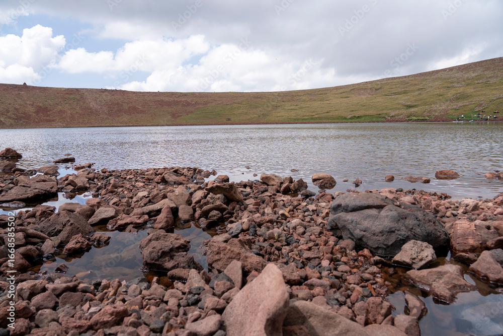 Remote Volcanic Lake in a Colorful Highland Crater Remote Volcanic Lake in a Colorful Highland Crater