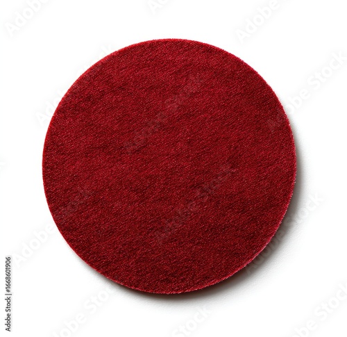 A rich, crimson-red circular felt pad, subtly textured, isolated on a stark white background; seemingly soft and possibly used for polishing or crafting