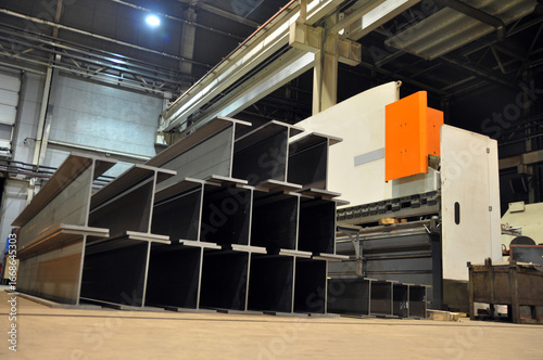 Manufacturing of a welded I-beam on an automatic welding line. Products of the plant for the production of metal structures.