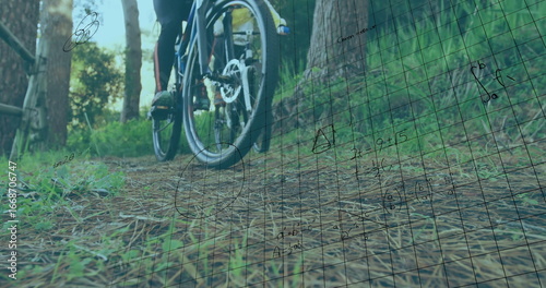 Foto Pedaling cyclist in black and red leggings navigating forest pine trail, with bi