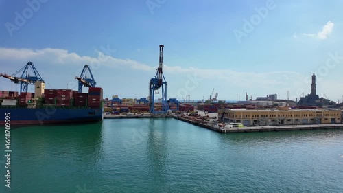 Genova, Italy. Busy industrial port with ships, cranes and containers under sunny sky and calm sea