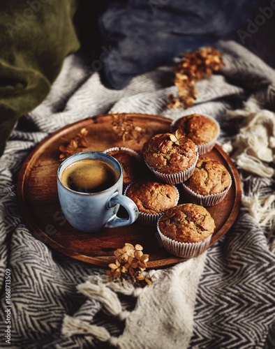 Peanut butter and banana muffins with cup of coffee in a cozy autumn style