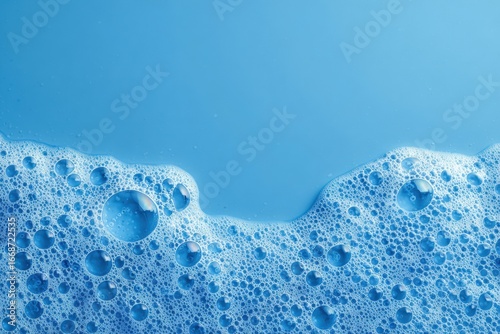 A vibrant blue surface with soapy foam